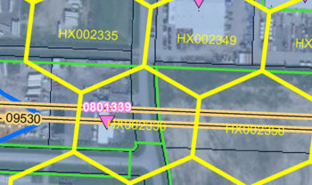 A detailed map displaying a network of hexagonal grids overlaid on an aerial view of an area with roads and buildings. The grids are highlighted with yellow lines, and each hexagon contains alphanumeric codes such as 'HX002335' and 'HX002349.' A pink triangle marker with the number '0801339' is prominently shown near the center, intersecting with a major road highlighted in yellow. The map is used for geographical or planning purposes.