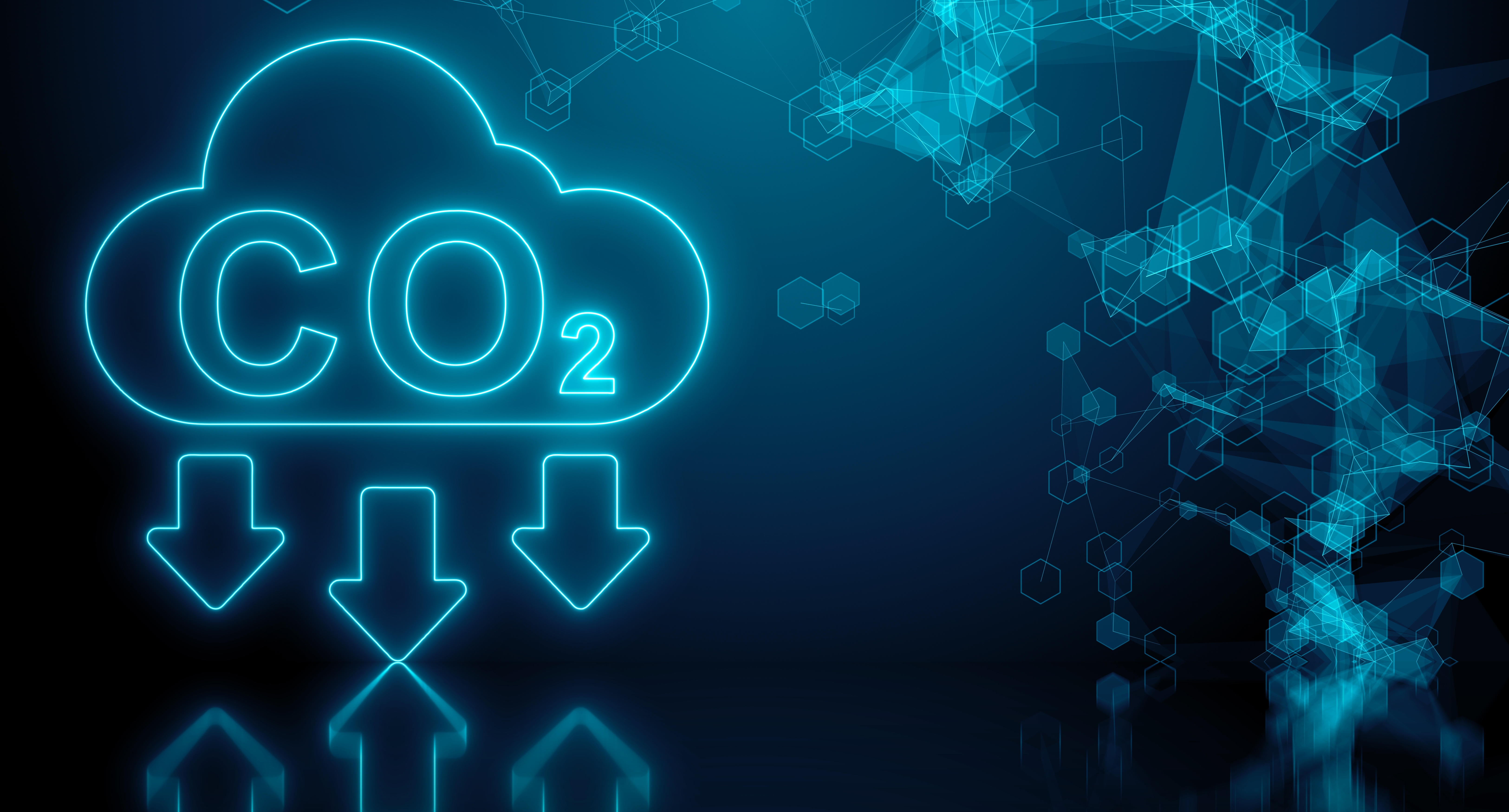A glowing neon blue graphic of a cloud with the chemical symbol 'CO₂' inside it. Below the cloud, three arrows point downward, symbolizing the reduction of carbon dioxide emissions. The background is dark blue with abstract hexagonal patterns, creating a modern and technological feel.